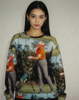 Woman wearing a sweater with a graphic of a person playing golf.