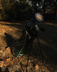 Golf club in a bag on a grassy area with trees in the background