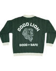 A dark forest green ribbed knit varsity-style jacket shown from the back, featuring a large white graphic of a roaring lion's head with the text 'GOOD LION' above and 'GOOD > SAFE' below, on a plain white background.