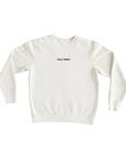 An off-white crewneck sweatshirt with the text 'GOLF SHIRT.' embroidered in black on the chest, displayed flat against a solid white background.