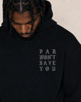 A man wearing a black pullover hoodie with the text 'PAR WON'T SAVE YOU' printed in a light gray gothic font on the left chest, set against a plain beige background.