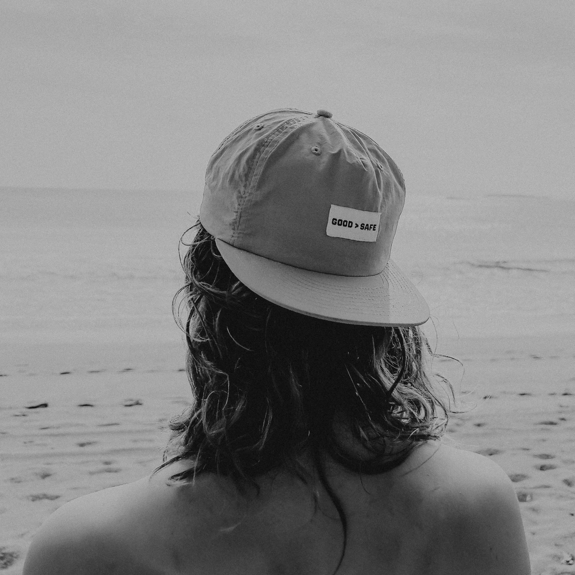 Person wearing a cap on a beach