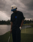 Person on a golf course with a cloudy sky