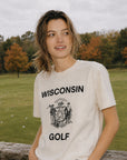 Person wearing a 'Wisconsin Golf' t-shirt standing outdoors with trees and grass in the background