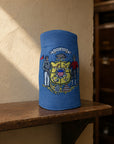 A blue cylindrical denim driver cover with an embroidered Wisconsin state coat of arms design, displayed on a wooden shelf against a textured beige wall.