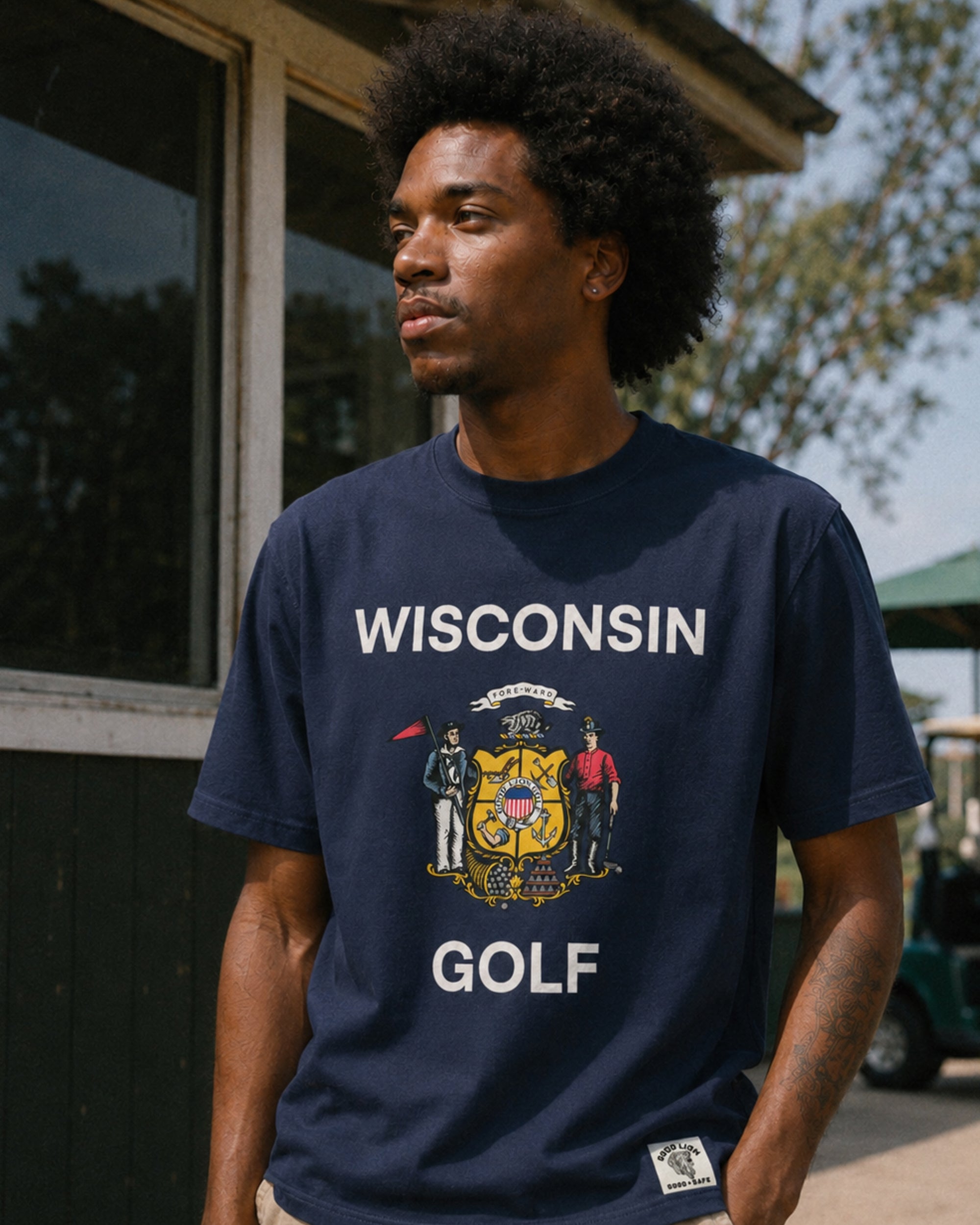 Person wearing a navy blue t-shirt with 'Wisconsin Golf' text and graphic